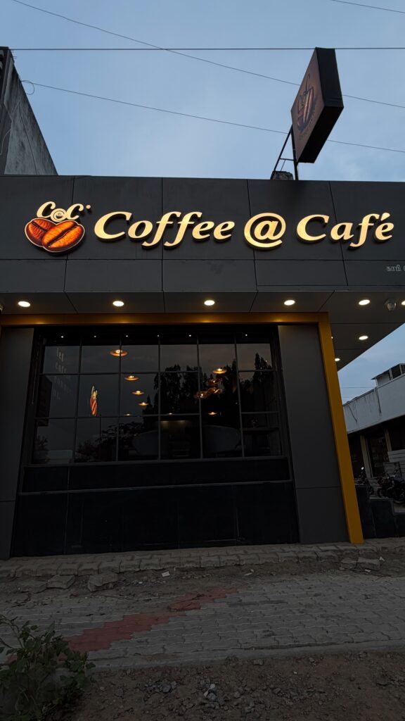 Coffee@Cafe Ambur sign lit up at dusk