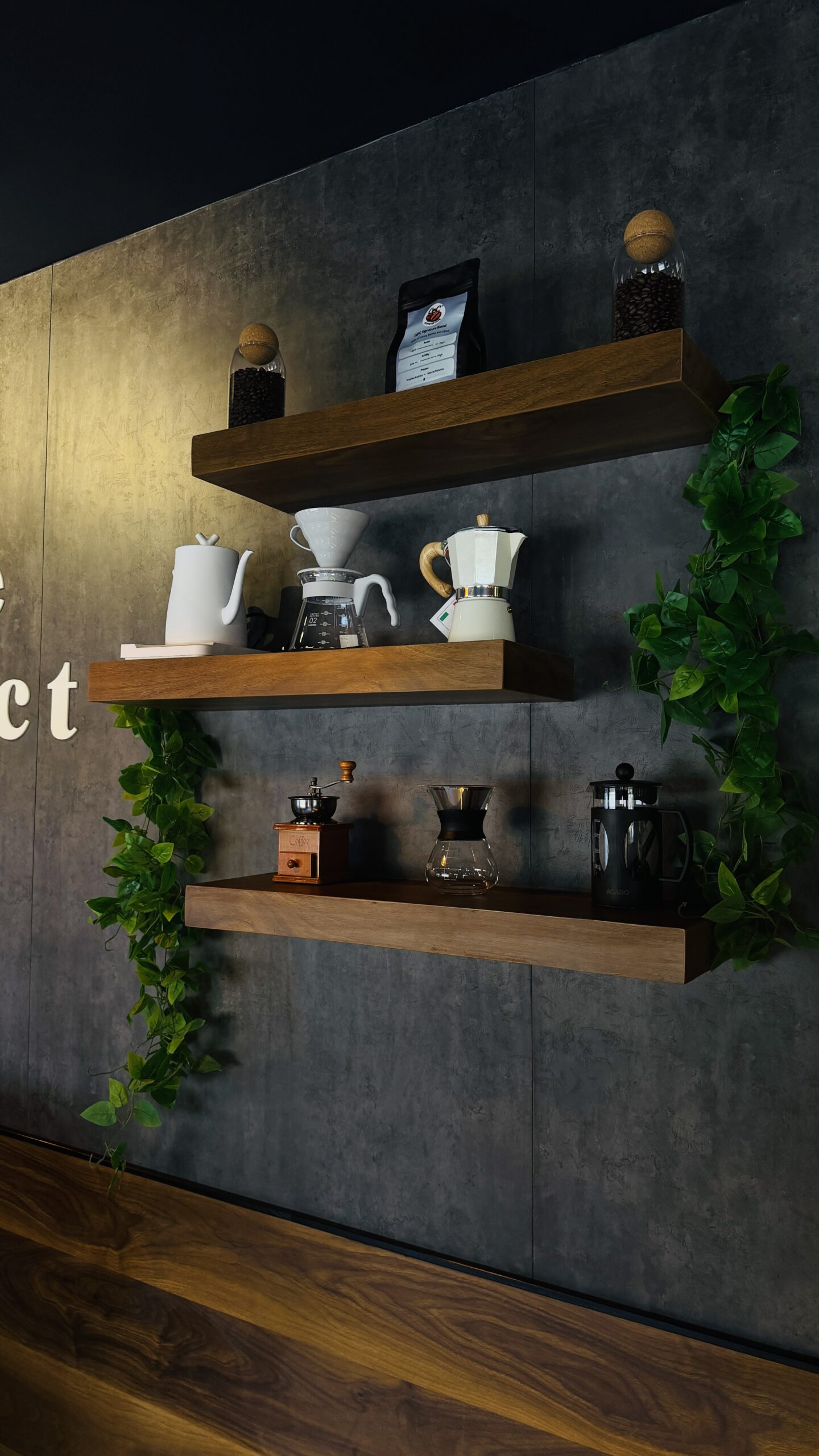 Wooden shelves with a kettle, pour-over, moka pot, hand grinder and French press