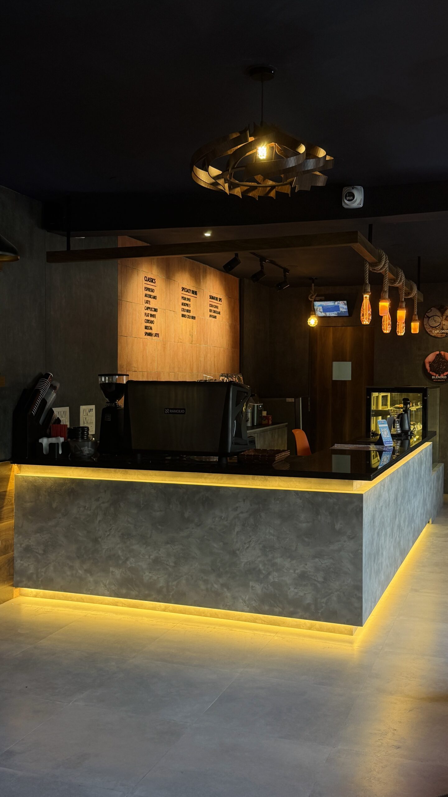 Counter with yellow underlighting and the menu board behind
